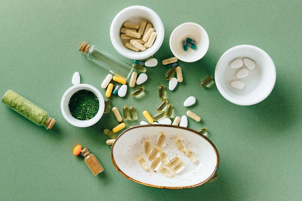 Supplement capsules and wellness products arranged in a clean editorial flat lay